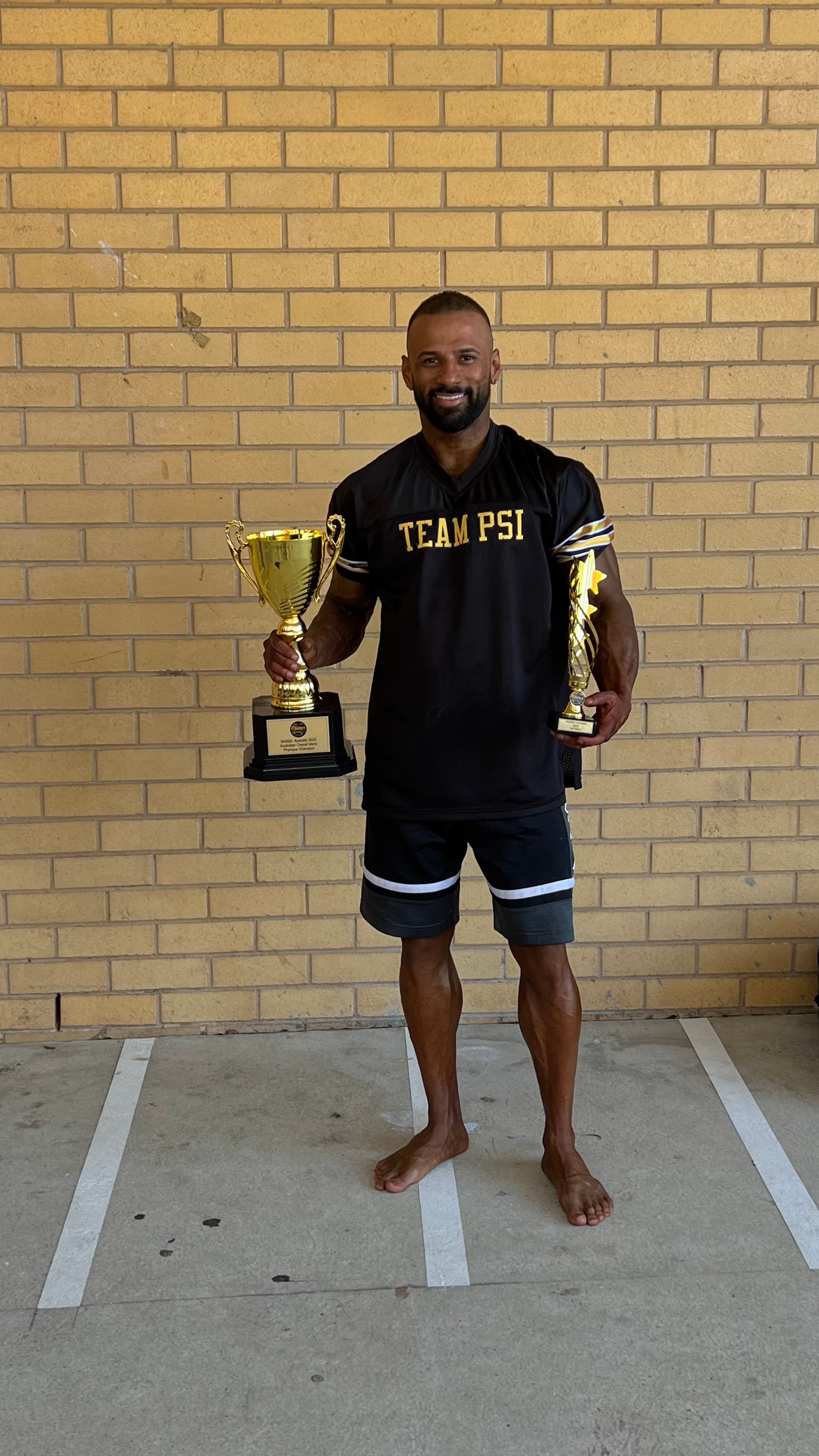 Puneet in Team PSI jersey holding championship trophies